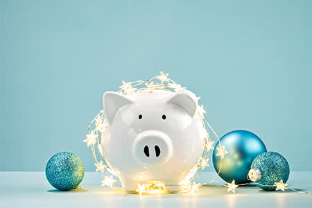 a bundle of money gift wrapped with a ribbon for the holiday